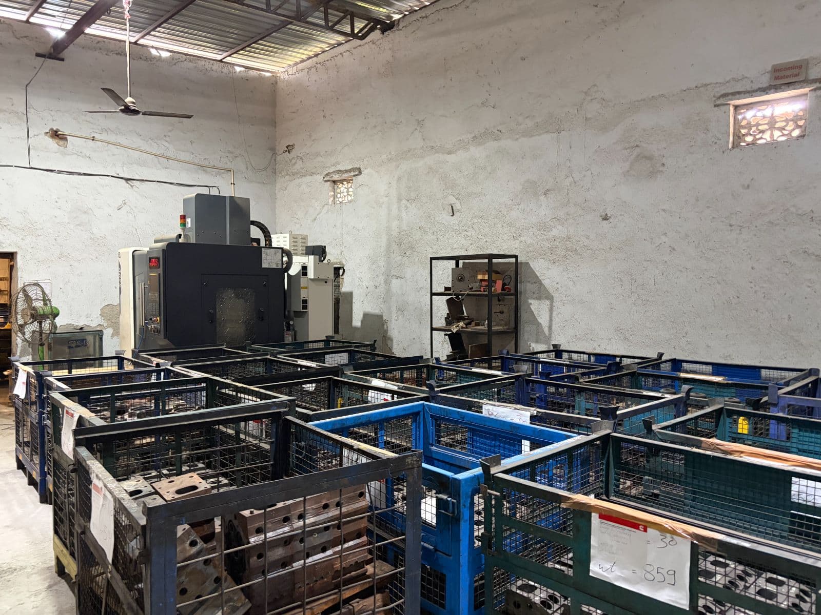 Mass Consultants shop floor: CNC machining centre with batches of components staged for production